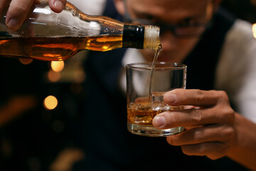 Barman pouring whiskey whiskey glass beautiful night