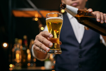 Barman pouring beer glass beautiful night