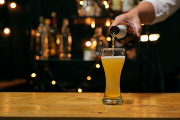 Barman pouring whiskey glass beautiful night