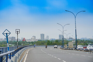 Kolkata, West Bengal, India - 21st June 2020 : View of Kolkata city and traffic on 2nd Hoogly Bridge. Victoria Memorial, a large marble buliding , icon of Kolkata in the background.