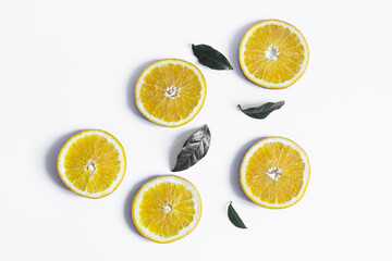 Background of orange slices and green leaves. Flatley of orange slices and leaves