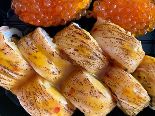 Sushi set of bali maki rolls and gunkans with red cavier close up. Delicious Japanese food. Top view
