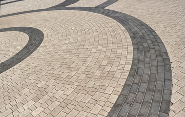Street gray striped pavement of polished paving stones.