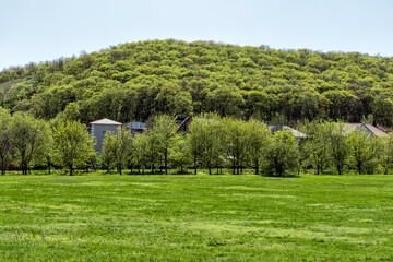 A small settlement on a hillside in the spring season on a sunny day.