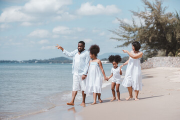 Summer vacation family. African American family playing together on the beach on holiday