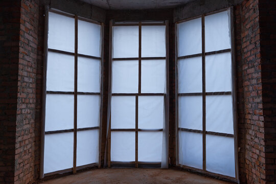 The entrance to an unfinished private house is sheathed with an opaque film, inside view