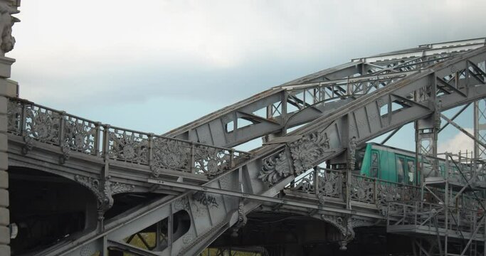 Old railway bridge. A train passes on a bow bridge with suspended deck which supports an elevated section.