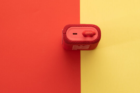 jerusalem-israel. 03-05-2021.  A small and portable speaker from the jbl company - model go3 in red - on a yellow red background