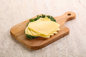 Sliced Gouda cheese over board