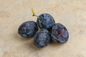 Ripe plum heap over background
