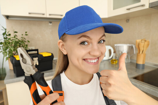 Concept of occupation, young woman plumber in uniform