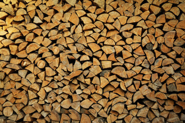Background of dry chopped firewood logs in a pile