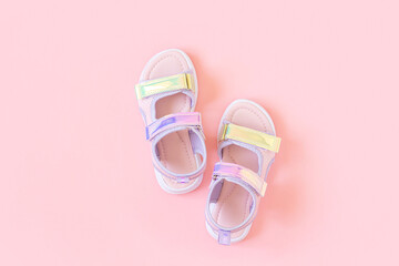 Stylish holographic sandals for kids on pink background. Shiny fashion summer shoes. Flat lay, Top...