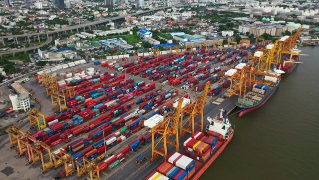 Time lapse view of container cargo ship in the export, import business, logistics and transportation. International goods in urban city. Shipping to the harbor by crane in Bangkok City, Thailand