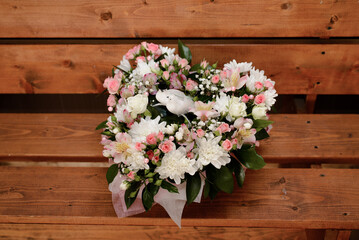 Bouquet of flowers in the shape of a heart on a wooden background. valentine's day
