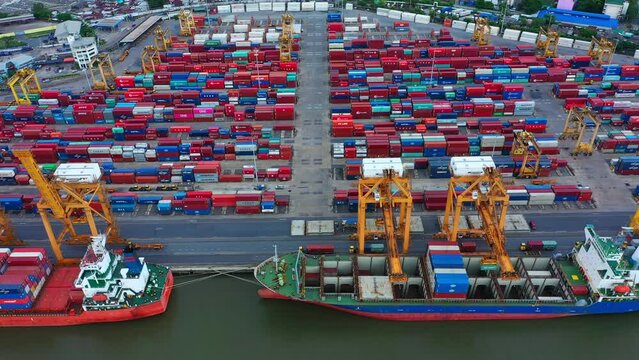 Aerial  view of container cargo ship in the export, import business, logistics and transportation. International goods in urban city. Shipping to the harbor by crane in Bangkok City, Thailand
