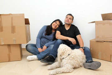 Couple of Latin man and woman move house thanks to a real estate agency they are happy for the...