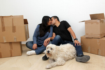 Couple of Latin man and woman move house thanks to a real estate agency they are happy for the beginning of a new life together and create a family
