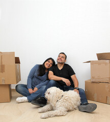Couple of Latin man and woman move house thanks to a real estate agency they are happy for the...