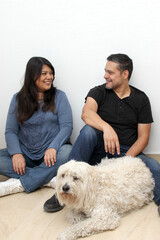 Couple of Latin man and woman move house thanks to a real estate agency they are happy for the beginning of a new life together and create a family
