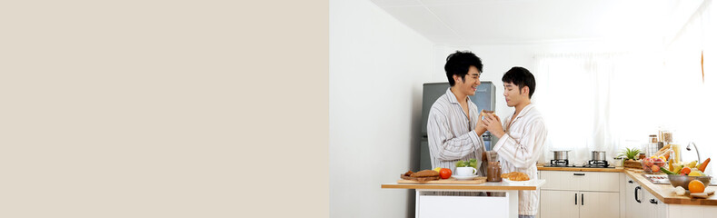 Banner Happy gay couple enjoy breakfast in kitchen drinking coffee. Panorama Two best friends LGBTQ relation partner home cooking. Wide Happiness romance homosexual marriage lifestyle with copy space