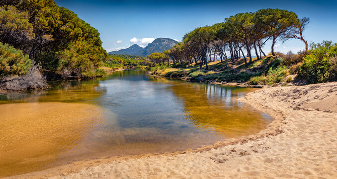 Empty spring view of Osala Beach with Petrosu mountain on background. Calm outdoor scene of Sardinia island, Italy, Europe. Beauty of nature concept background..