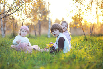 Young family on a walk in the autumn park on a sunny day. Happiness to be together.