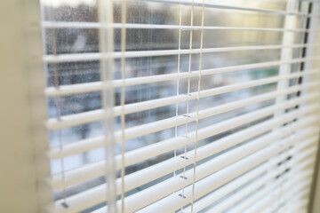 Metal blinds on the window. The texture of the blinds. Blinds background.