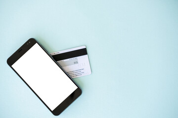Bank payments. Mobile mockup. Online technology. Smartphone with white blank screen and plastic credit card isolated blue copy space.