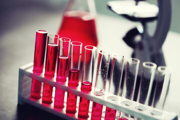 Microscopic examination of blood. Test tubes with red liquid on the laboratory table.