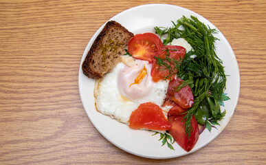 Breakfast on a plate, scrambled eggs and greens