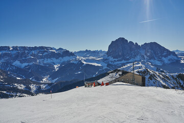 Beautiful Winter Landscape in the Val Gardena. Sassolungo Mountain in the background. Wide Winter Landscape