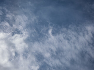 View of blue sky with white clouds in a sunny day. Background of sky with patchy clouds