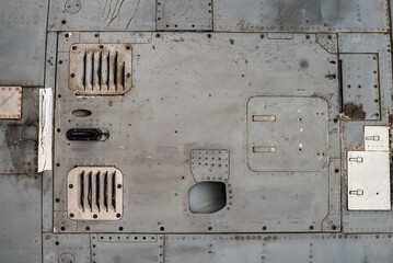 Aluminum surface of the aircraft fuselage.  Sheet metal riveted. Aircraft skin close up. Rivets on...