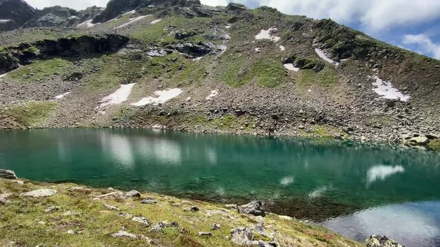 Beautiful turquoise Oberer Plenderlessee with nice reflections and great mountains in the background, very close to K&uuml;htai in Tyrol, Austria