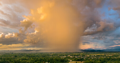 The thunderstorm clouds with the rain at sunset in Chiang Mai Thailand.