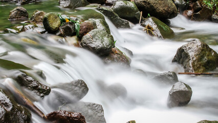 Water is flowing in jungle. Nature abstract background. Granite rock mountain