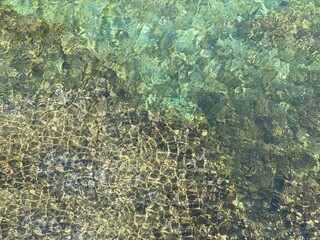 Sea water green clear reef seaweed surface. Glittering transparent sea waters. Beautiful seascape.