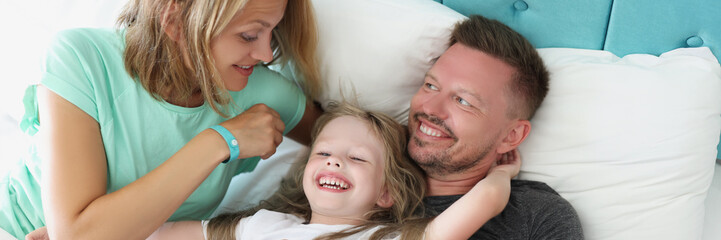 Smiling dad mum and kid together