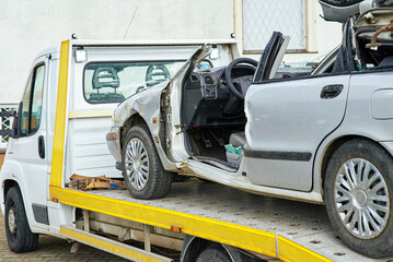 Wrecked car loading on tow truck after crash traffic accident, Concept of dangerous driving after...