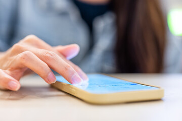 Close up of woman use mobile phone on table