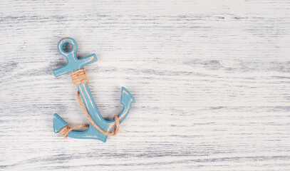 Blue anchor on a white textured background, maritime sea life, sailing trip, summer vacation,...