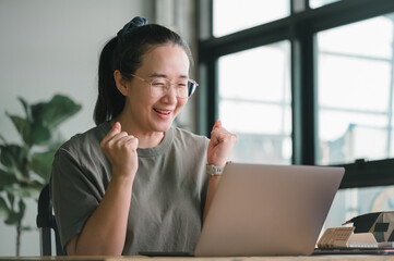 Amazed and happy excited Asia female feeling euphoric celebrating online, young woman happy about...