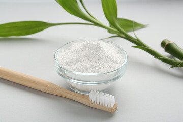 Tooth powder, brush and bamboo stem on white background, closeup