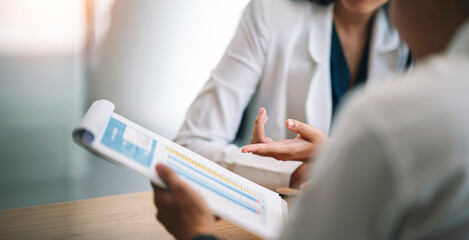 Businessman advisor, two business people talking, planning analyze investment and marketing on tablet in office.