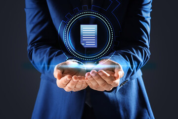 Man holding virtual icon of computer file on dark background, closeup