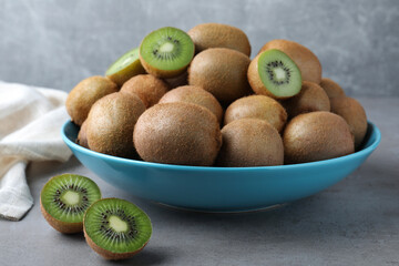 Fresh ripe kiwis on light grey table