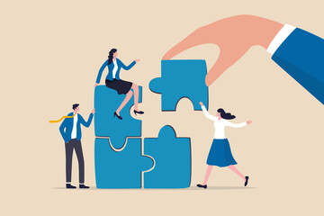 Build your team, leadership to develop teamwork or business partner, cooperate or collaborate for success, assist or help, giant businessman hand connect last jigsaw puzzle to office business team. - obrazy, fototapety, plakaty