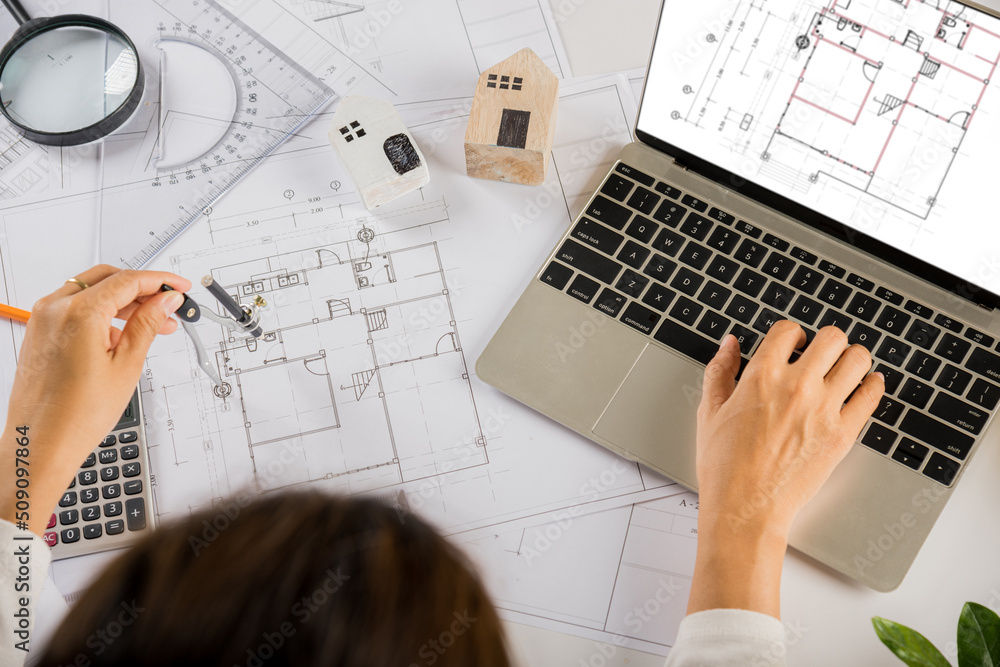 Poster architectural project workplace. architect typing laptop keyboard to review design of house before e