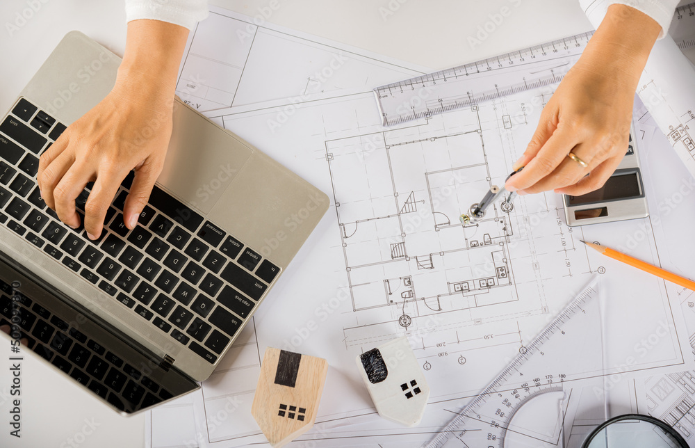 Poster architectural project workplace. architect typing laptop keyboard to review design of house building